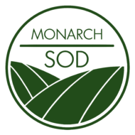 A circular logo with a white border and a gray background, featuring the words 'MONARCH' above a horizontal line and 'SOD' below it in dark green, over stylized dark green rolling hills or fields.